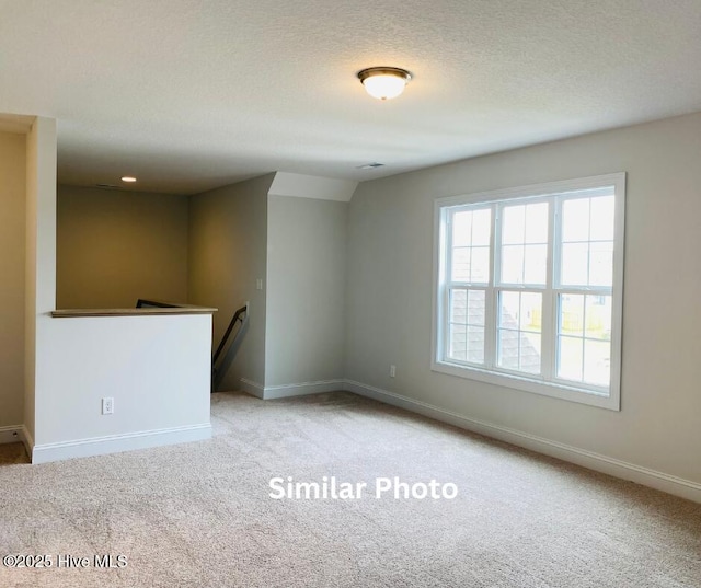 635 Indigo Johnston Dr, Jacksonville, NC 28546 - carpeted spare room featuring baseboards and a textured ceiling
