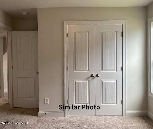 635 Indigo Johnston Dr, Jacksonville, NC 28546 - unfurnished bedroom featuring a closet, carpet floors, and baseboards
