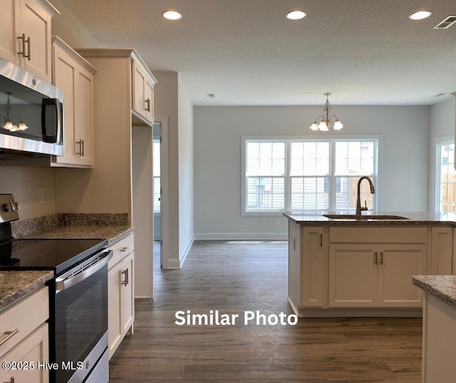 635 Indigo Johnston Dr, Jacksonville, NC 28546 - kitchen with appliances with stainless steel finishes, a sink, a chandelier, dark wood-style flooring, and recessed lighting