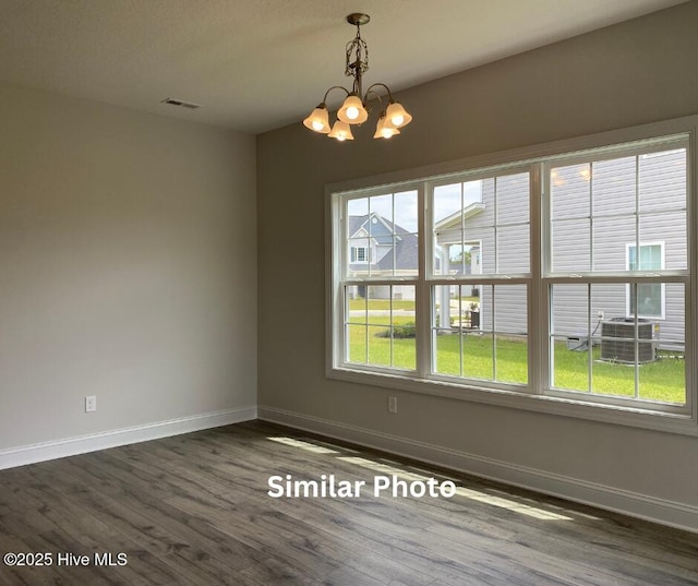 635 Indigo Johnston Dr, Jacksonville, NC 28546 - unfurnished dining area with baseboards, a chandelier, and dark wood-style floors