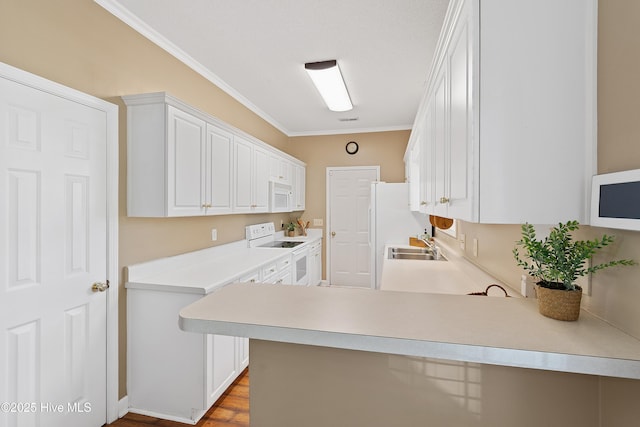 4379 Owendon Dr, Shallotte, NC 28470 - kitchen with white appliances, ornamental molding, white cabinetry, light countertops, and a sink