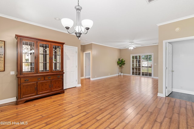 4379 Owendon Dr, Shallotte, NC 28470 - spare room featuring ceiling fan, a chandelier, crown molding, light wood-style flooring, and baseboards