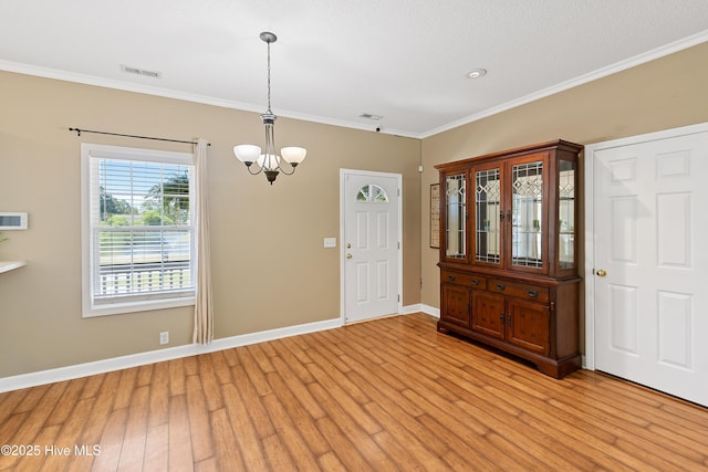 4379 Owendon Dr, Shallotte, NC 28470 - entryway featuring a chandelier, light wood finished floors, crown molding, and baseboards