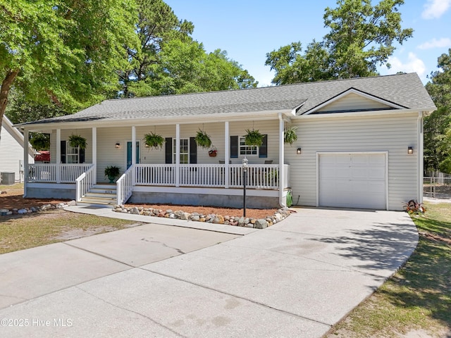 4379 Owendon Dr, Shallotte, NC 28470 - ranch-style home featuring a porch, concrete driveway, a garage, and a shingled roof