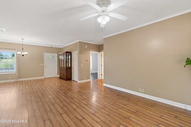 4379 Owendon Dr, Shallotte, NC 28470 - unfurnished living room with a chandelier, a ceiling fan, baseboards, crown molding, and wood finished floors
