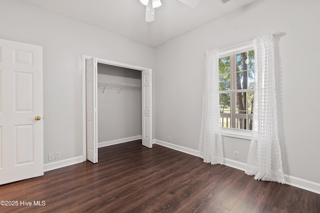 4379 Owendon Dr, Shallotte, NC 28470 - unfurnished bedroom with dark wood finished floors, baseboards, a closet, and ceiling fan