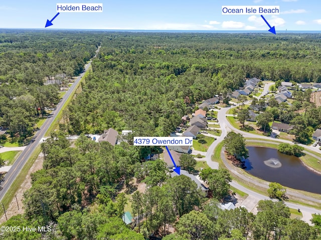 4379 Owendon Dr, Shallotte, NC 28470 - aerial perspective of suburban area featuring a forest and a nearby body of water
