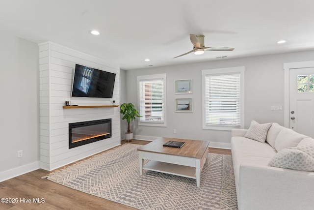1015 E Moore St, Southport, NC 28461 - living area with ceiling fan, wood finished floors, baseboards, recessed lighting, and a large fireplace