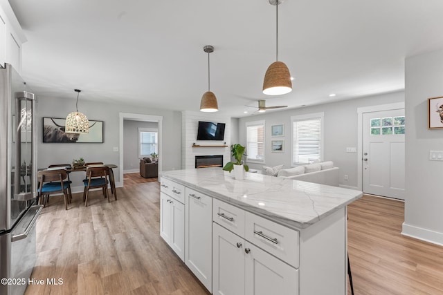 1015 E Moore St, Southport, NC 28461 - kitchen with high end refrigerator, open floor plan, light wood finished floors, plenty of natural light, and recessed lighting