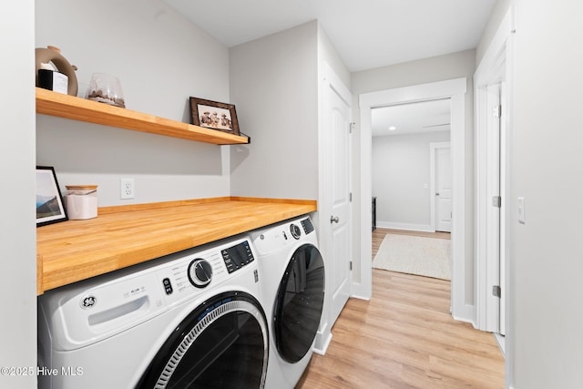 1015 E Moore St, Southport, NC 28461 - washroom with independent washer and dryer, light wood-type flooring, and baseboards