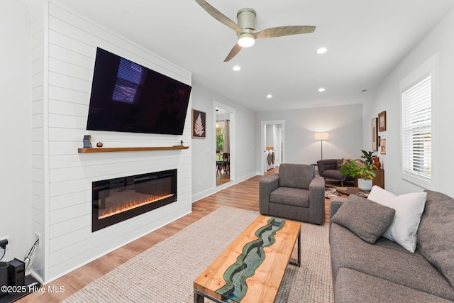 1015 E Moore St, Southport, NC 28461 - living area featuring wood finished floors, a glass covered fireplace, recessed lighting, and a ceiling fan