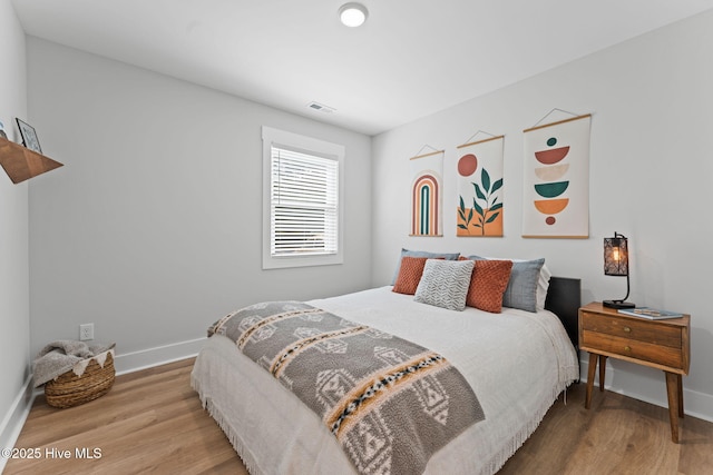 1015 E Moore St, Southport, NC 28461 - bedroom with baseboards and wood finished floors