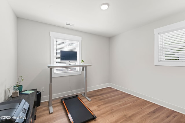 1015 E Moore St, Southport, NC 28461 - exercise room with light wood-type flooring and baseboards