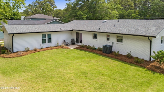 1015 E Moore St, Southport, NC 28461 - back of house with a shingled roof, a yard, central AC unit, brick siding, and a patio