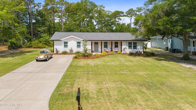 1015 E Moore St, Southport, NC 28461 - single story home with driveway, a front yard, covered porch, and central air condition unit