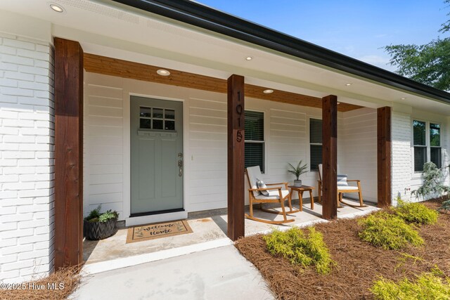 1015 E Moore St, Southport, NC 28461 - single story home with concrete driveway, a front yard, and a porch