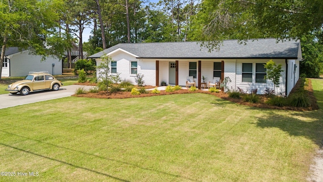 1015 E Moore St, Southport, NC 28461 - ranch-style home with covered porch, brick siding, and a front yard