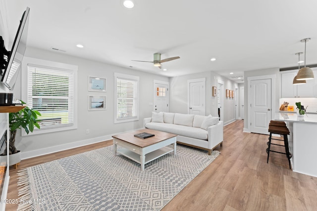 1015 E Moore St, Southport, NC 28461 - living room featuring plenty of natural light, light wood-style flooring, a ceiling fan, and recessed lighting