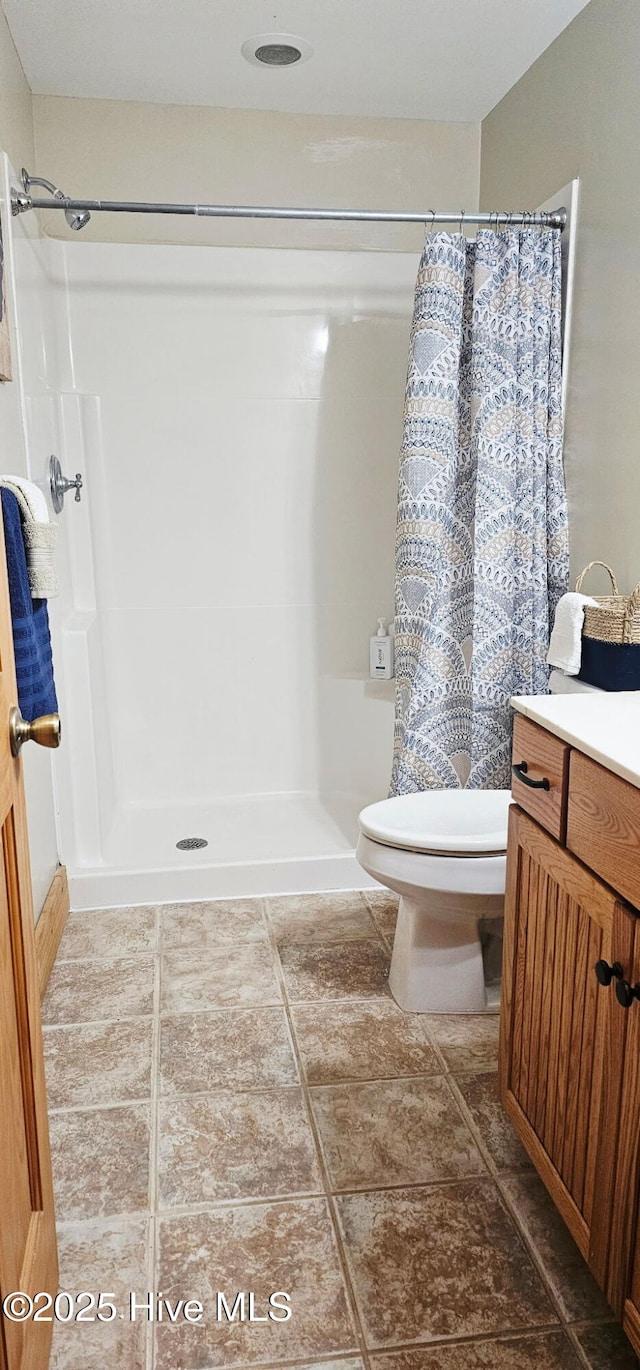 520 Holly Ridge Rd, Holly Ridge, NC 28445 - full bath with toilet, vanity, a shower with shower curtain, and tile patterned flooring