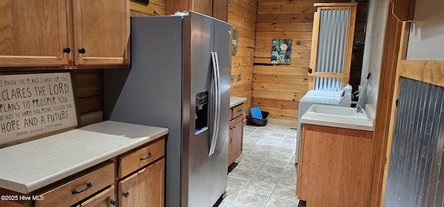 520 Holly Ridge Rd, Holly Ridge, NC 28445 - kitchen featuring stainless steel fridge, wooden walls, brown cabinets, and light countertops