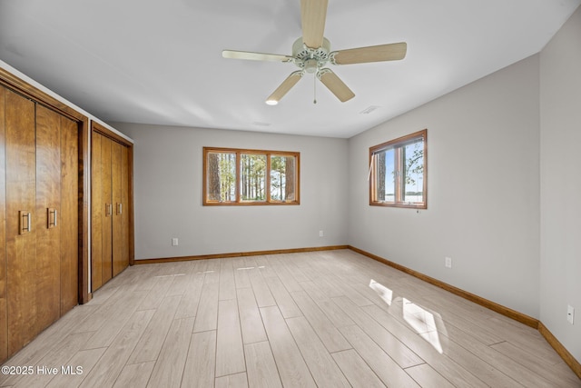 153 Windmill Point Dr, Vandemere, NC 28587 - unfurnished bedroom featuring multiple windows, light wood-style floors, and baseboards