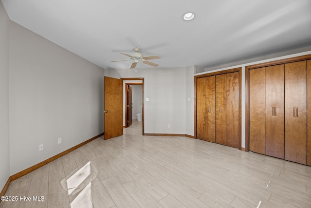 153 Windmill Point Dr, Vandemere, NC 28587 - unfurnished bedroom featuring two closets, baseboards, light wood-style flooring, and ceiling fan