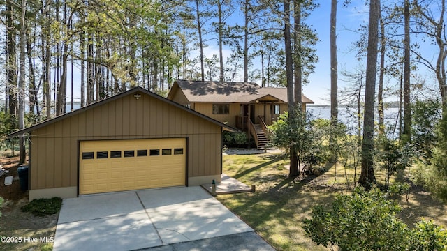 153 Windmill Point Dr, Vandemere, NC 28587 - view of front of house featuring stairway, an outbuilding, a detached garage, and concrete driveway