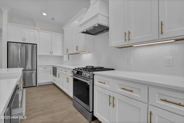 8241 Sage Valley Dr, Wilmington, NC 28411 - kitchen featuring appliances with stainless steel finishes, premium range hood, white cabinetry, light countertops, and recessed lighting