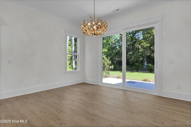 8241 Sage Valley Dr, Wilmington, NC 28411 - unfurnished room featuring a chandelier, wood finished floors, and baseboards