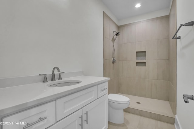 8241 Sage Valley Dr, Wilmington, NC 28411 - bathroom featuring a tile shower, toilet, vanity, tile patterned flooring, and recessed lighting