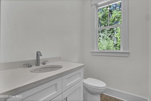 8241 Sage Valley Dr, Wilmington, NC 28411 - bathroom with plenty of natural light, toilet, vanity, and wood finished floors
