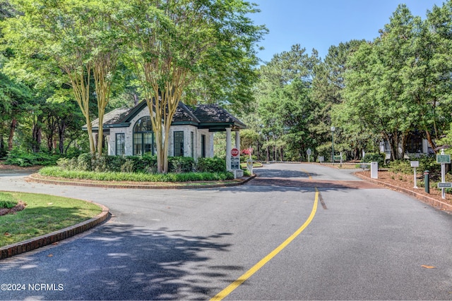 8241 Sage Valley Dr, Wilmington, NC 28411 - view of asphalt road with traffic signs and curbs