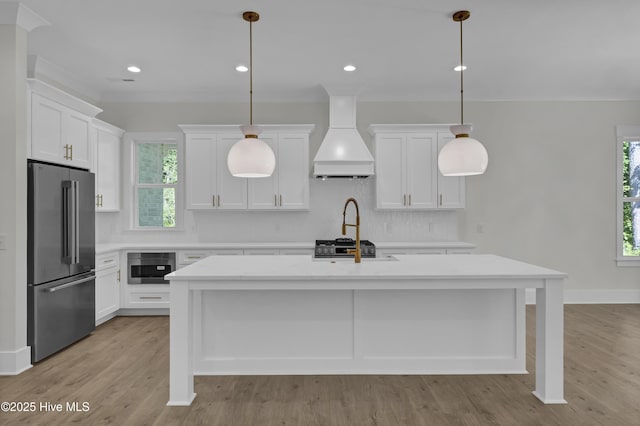 8241 Sage Valley Dr, Wilmington, NC 28411 - kitchen with high end fridge, custom range hood, light countertops, an island with sink, and tasteful backsplash