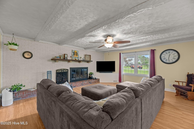 4912 Cypress Shores Dr, New Bern, NC 28562 - living area with wood finished floors, a ceiling fan, and a fireplace