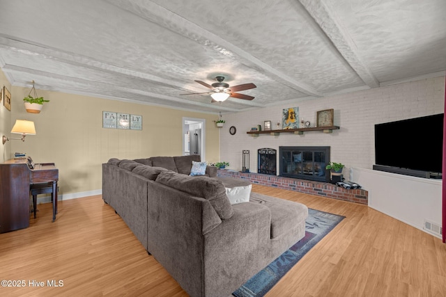 4912 Cypress Shores Dr, New Bern, NC 28562 - living area with wood finished floors, a brick fireplace, a ceiling fan, and baseboards