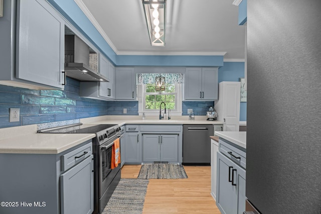4912 Cypress Shores Dr, New Bern, NC 28562 - kitchen with stainless steel appliances, wall chimney exhaust hood, ornamental molding, gray cabinets, and a sink