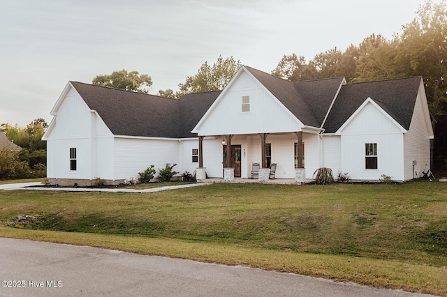 187 Royal Palms Way, Holly Ridge, NC 28445 - modern farmhouse featuring a porch, a front yard, and a shingled roof