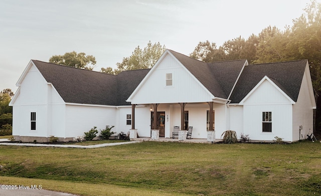 187 Royal Palms Way, Holly Ridge, NC 28445 - modern farmhouse featuring a front lawn, covered porch, and a shingled roof