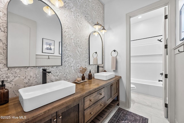 187 Royal Palms Way, Holly Ridge, NC 28445 - full bath with wallpapered walls, double vanity, toilet, and  shower combination