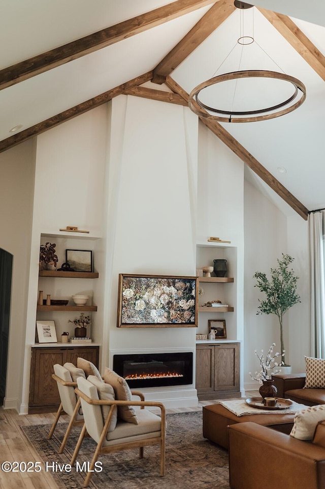 187 Royal Palms Way, Holly Ridge, NC 28445 - living area featuring wood finished floors, a glass covered fireplace, built in features, beamed ceiling, and high vaulted ceiling