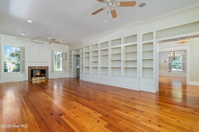 588 E Harborside Rd, Oriental, NC 28571 - unfurnished living room with ceiling fan, hardwood / wood-style flooring, recessed lighting, ornamental molding, and a fireplace