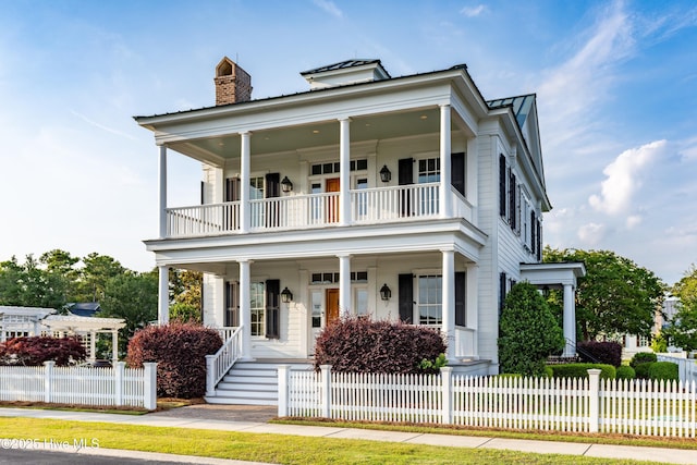 588 E Harborside Rd, Oriental, NC 28571 - neoclassical home with a balcony, a porch, a chimney, and metal roof