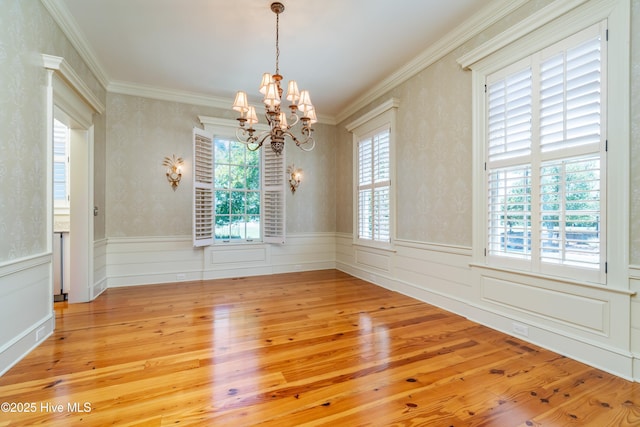 588 E Harborside Rd, Oriental, NC 28571 - unfurnished room featuring a chandelier, light wood-style floors, a wainscoted wall, and crown molding