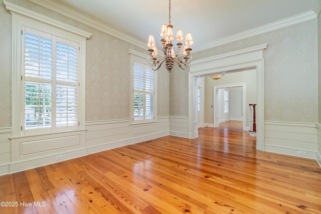 588 E Harborside Rd, Oriental, NC 28571 - spare room with a chandelier, a wainscoted wall, wood finished floors, and crown molding