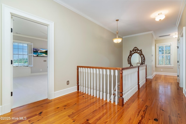 588 E Harborside Rd, Oriental, NC 28571 - hallway with an upstairs landing, ornamental molding, wood finished floors, and baseboards