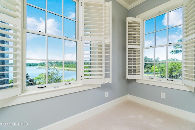 588 E Harborside Rd, Oriental, NC 28571 - spare room featuring baseboards, crown molding, a water view, and carpet floors