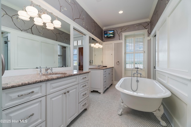 588 E Harborside Rd, Oriental, NC 28571 - bathroom with vanity, a freestanding tub, ornamental molding, a decorative wall, and a chandelier