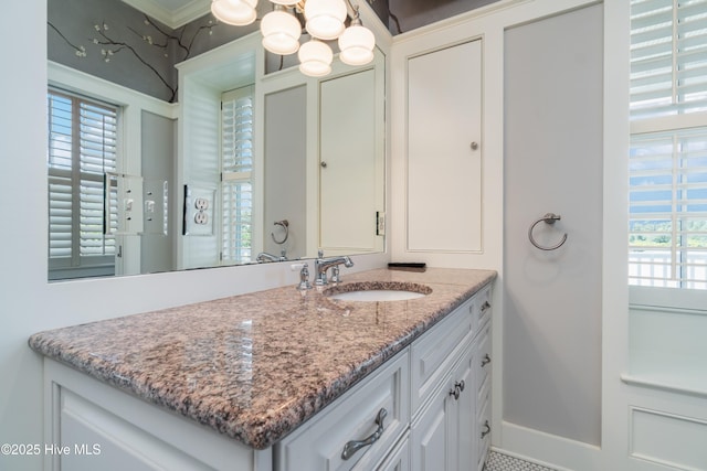 588 E Harborside Rd, Oriental, NC 28571 - bathroom featuring vanity, healthy amount of natural light, a chandelier, and crown molding