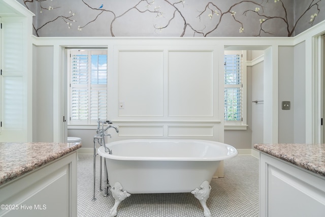 588 E Harborside Rd, Oriental, NC 28571 - bathroom featuring vanity, a freestanding tub, baseboards, and healthy amount of natural light