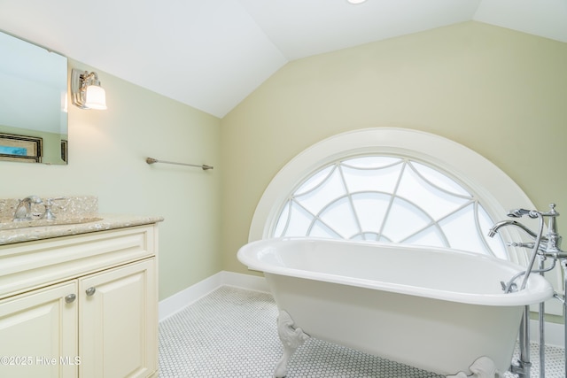 588 E Harborside Rd, Oriental, NC 28571 - bathroom featuring vaulted ceiling, a freestanding bath, vanity, plenty of natural light, and tile patterned floors